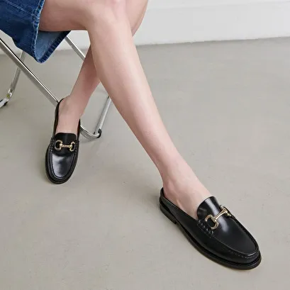 Moccasins with golden jaws in black shiny leather