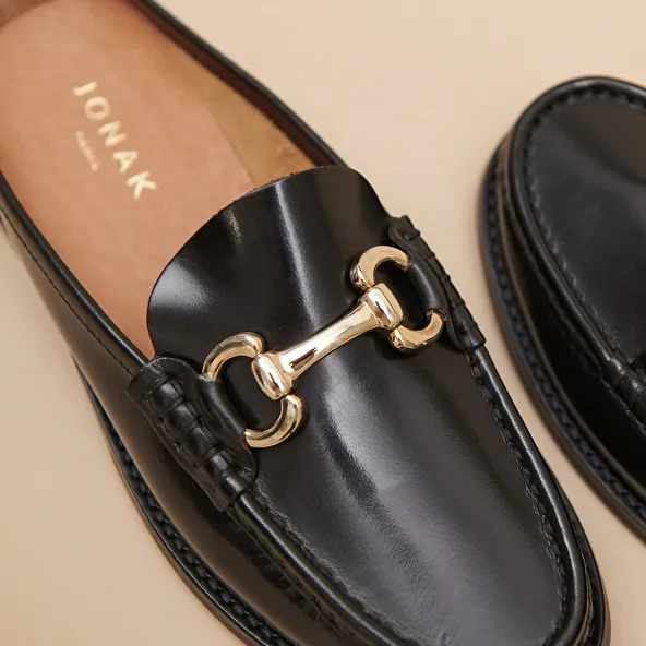 Moccasins with golden jaws in black shiny leather